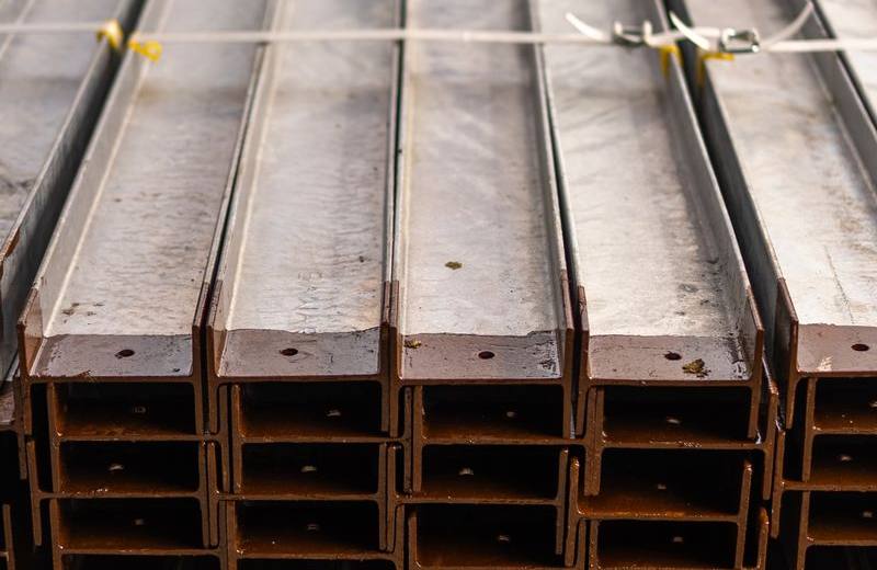 Neatly stacked new hot-rolled structural steel beams